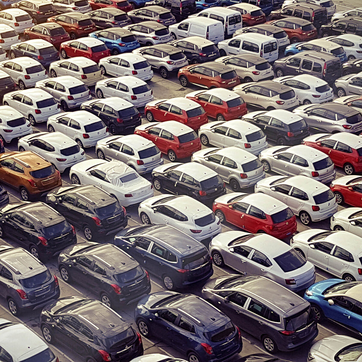 Lot full of many different types and colours of cars