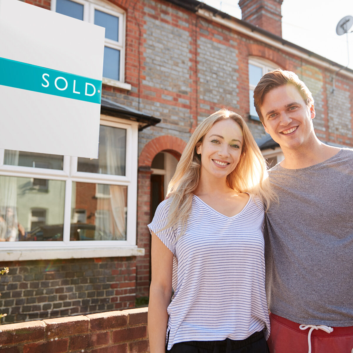 Couple young moving house conveyancing happy sold sign 1273188052